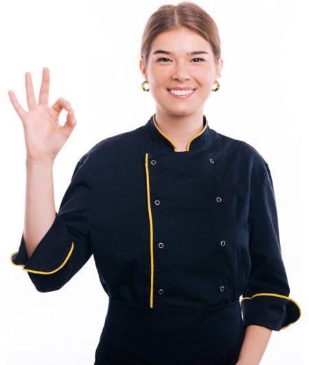 Charming young chef woman in uniform showing ok gesture over white background