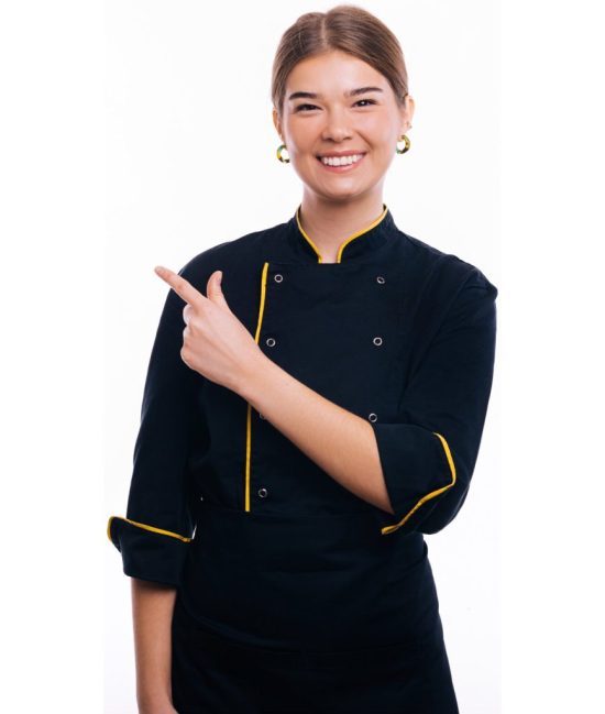 Cheerful young Chef woman pointing at copyspace over white background and smiling